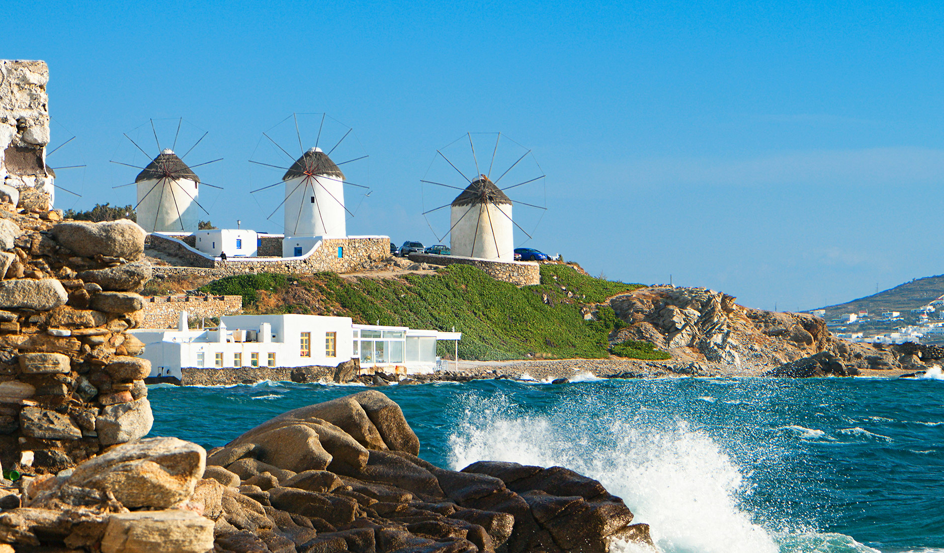 Mykonos Windmills - Turquoise waters, a refreshing sea breeze, and a majestic skyline adorned with the iconic Mykonos Windmills