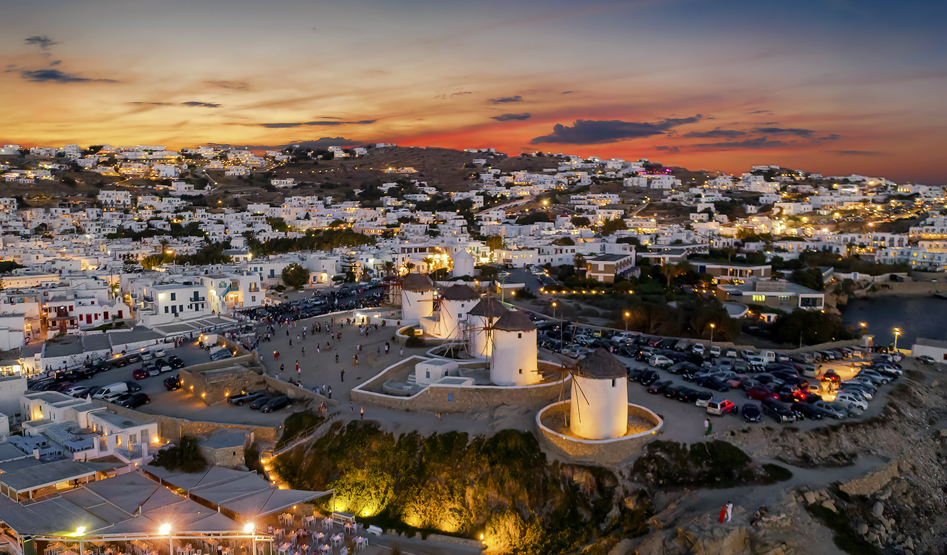 Visiting Mykonos Windmills during the golden hour, either at sunrise or sunset