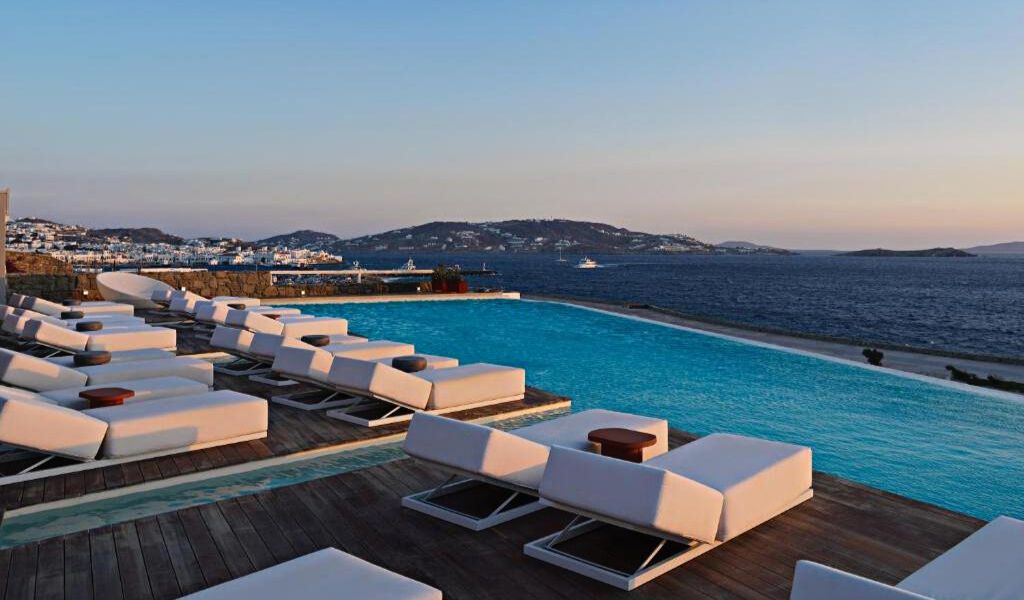 Relaxing by the Pool of Kouros Hotel & Suites while Gazing the Aegean Sea