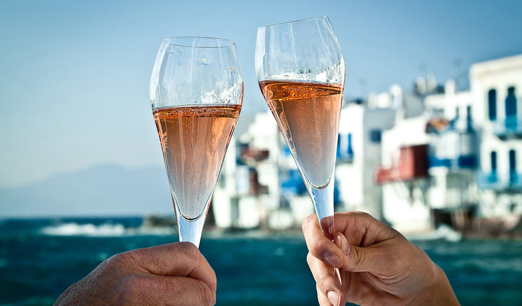 Sipping champagne in Mykonos Town with Little Venice in the background